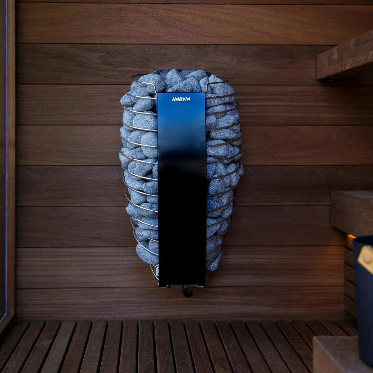 Custom indoor sauna interior with a sauna heater and stones
