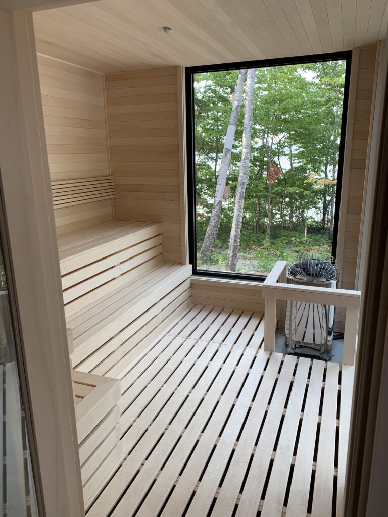 Luxury outdoor sauna interior with a floor-to-ceiling window