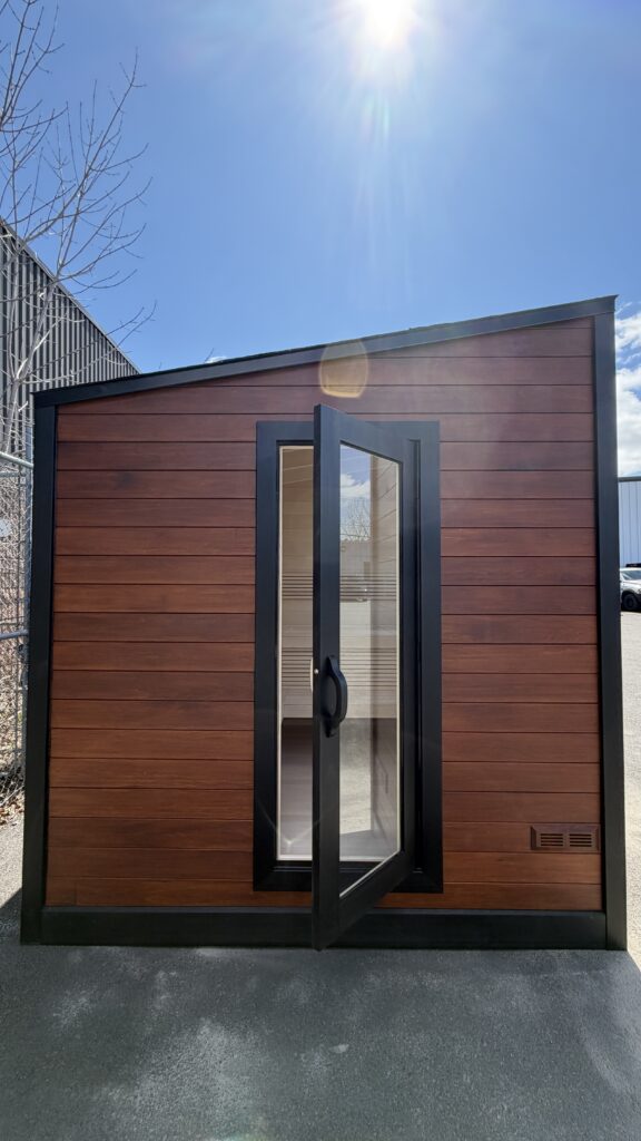 Modern outdoor sauna with a full glass door
